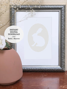 ivory rabbit cameo art print shown in silver frame with terra-cotta vase