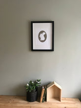 Load image into Gallery viewer, Giclee Art print of gray squirrel holding acorn in white fine art paper shown in frame hanging on wall
