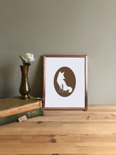 Load image into Gallery viewer, Fox cameo art print on white paper shown in copper frame on table with vase
