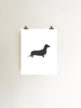Load image into Gallery viewer, dachshund silhouette art print in black and white hanging with clips
