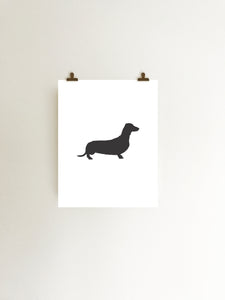 dachshund silhouette art print in black and white hanging with clips