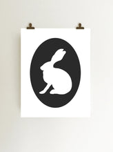 Load image into Gallery viewer, Black rabbit cameo giclee art print on white fine art paper shown hanging from clips on wall
