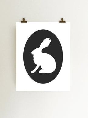 Black rabbit cameo giclee art print on white fine art paper shown hanging from clips on wall