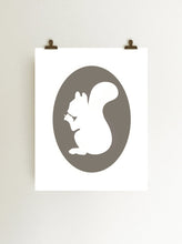 Load image into Gallery viewer, Gray squirrel holding acorn cameo art print, giclee on white fine art print paper shown hanging on wall from clips
